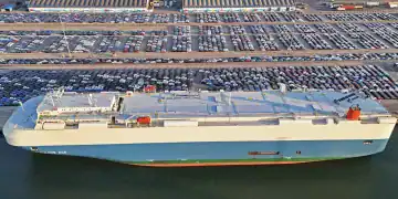 YANTAI, CHINA - MARCH 30: Aerial view of vehicles waiting to be loaded onto a ro-ro ship for export at Yantai Port on March 30, 2025 in Yantai, Shandong Province of China. (Photo by Sun Wentan/VCG via Getty Images)